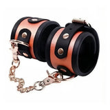 Menottes Cuir Bicolore Chaîne Or Rose : menottes noir et cognac reliées par une chaîne, photo 1